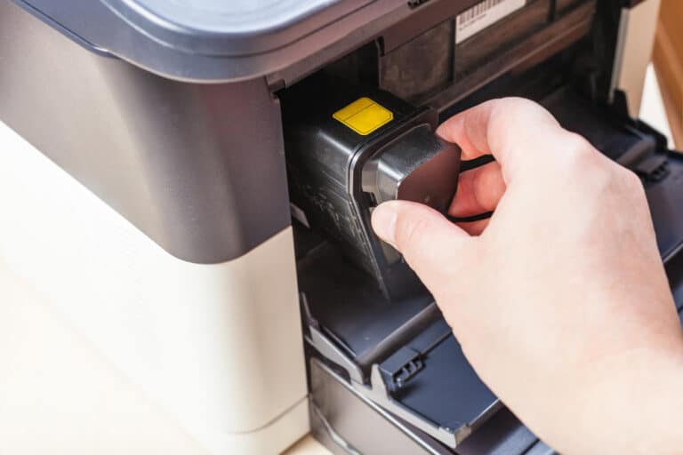 a person inserting a card into an atm machine