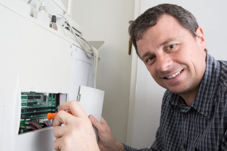 a man is working on an electrical panel